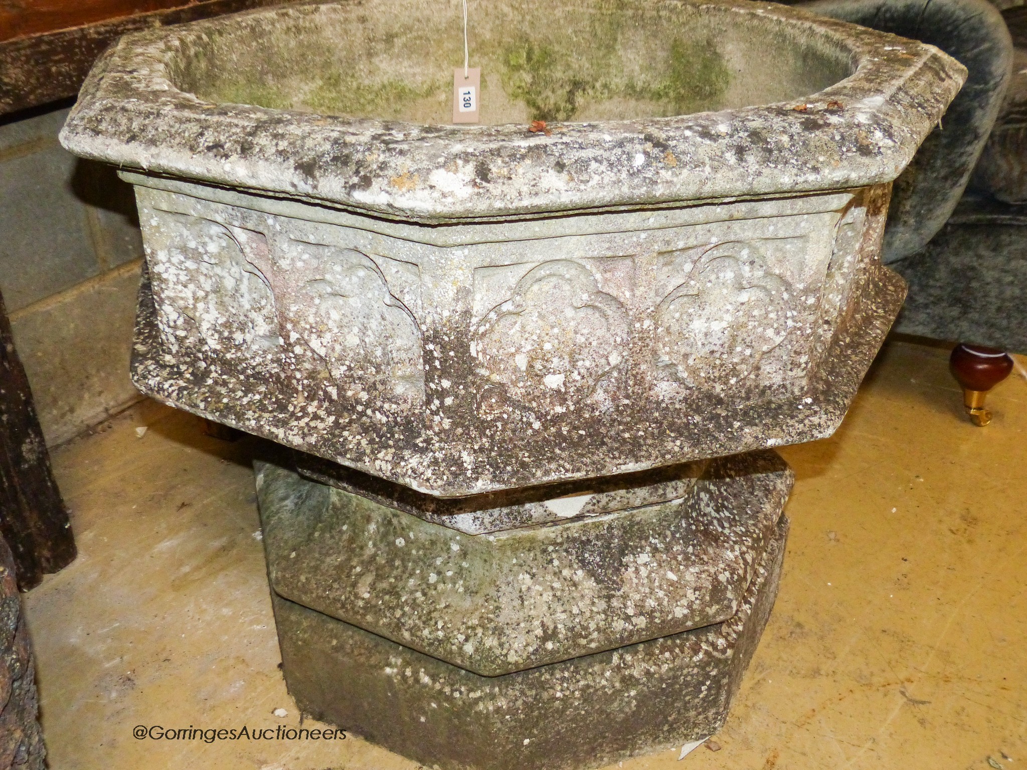 A large weathered Victorian octagonal carved stone font, width 80cm, height 67cm